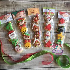 decorated cookies in the shape of santa's helpers