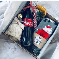 a box filled with assorted items on top of a white tablecloth covered bed