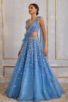 Blue attached cancan lehenga with sequin, zari thread, bead, stone embroidery in periwinkle pattern. Paired with sleeveless embroidered padded blouse and drape. - Aza Fashions Blue Organza Lehenga With Mirror Work, Blue Embellished Organza Lehenga, Blue Organza Lehenga With Sequins, Blue Sequin Organza Lehenga, Cancan Lehenga, Stone Embroidery, Tulle Embroidery, Padded Blouse, Blue Tulle