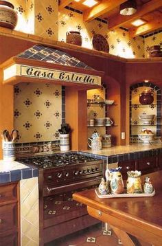 a kitchen with an oven, stove and counter top in the middle of it's center island