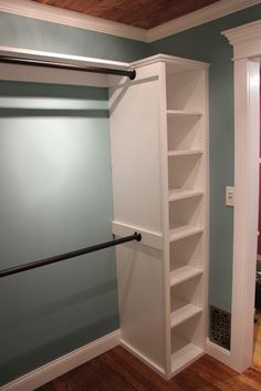 an empty bathroom with shelves on the wall