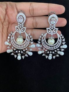 Elevate your look with these Victorian Chandbali earrings. Crafted from high-quality materials, these earrings boast an intricate design that adds an aura of elegance and sophistication to any look. Perfect for any occasion, these party wear earrings will complete your outfit with a timeless and classic finish. Luxury Formal Bridal Chandbali Sets, Luxury Silver Chandbali Bridal Sets, Luxury Chandbali Danglers With Latkans, Luxury Hallmarked Chandbali Danglers, Luxury Chandbalis For Formal Occasions, Elegant Chandbali Hoop Earrings For Celebration, Elegant Chandbalis With Intricate Design For Reception, Party Chandbali Chandelier Earrings With Elegant Design, Chandbali Chandelier Earrings With Intricate Design For Reception