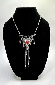 Dripping Heart & Skull Necklace. Silver, gothic bleeding heart necklace. Adjustable clasp. Red beads drip down the sides and bottom of the heart. Fun accessory for your Halloween costumes. Gothic Halloween Necklace With Lobster Clasp, Punk Heart Charm Necklace For Valentine's Day, Gothic Metal Heart Necklace, Punk Style Heart Charm Necklace For Valentine's Day, Gothic Heart-shaped Necklace For Valentine's Day, Gothic Heart Necklace With Heart Charm, Gothic Heart Necklace With Heart Pendant, Gothic Metal Necklace With Heart Pendant, Gothic Heart Pendant Metal Necklace