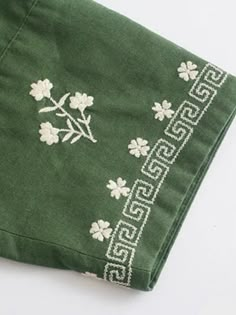 a green handkerchief with white flowers on it