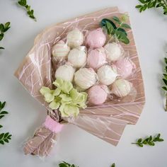 a bouquet of flowers and chocolates wrapped in cellophane