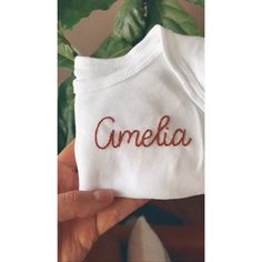 "As seen in the \"Meagan and Harry\" Netflix documentary. A custom baby bodysuit featuring their carefully picked name hand embroidered in richly colored thread. Perfect for newborn photos or a baby shower gift! Bodysuits are white Honest brand in either long or short sleeve. Sizes go from NB to 18 months. Embroidery options are a single word over the heart, a double stacked word over the heart or up to two words across the chest. Please note that the longer the word and the tinier the bodysuit, Embroidered Onesie, Embroider Ideas, Clothes Embroidery Diy, Custom Baby Onesies, Custom Baby Clothes, Name Embroidery, Embroidery On Clothes, Baby Hands, Baby Shirts