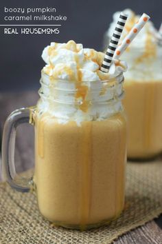 two mason jars filled with whipped cream and caramel milkshake