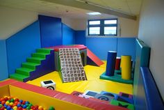 an indoor play area with balls and toys