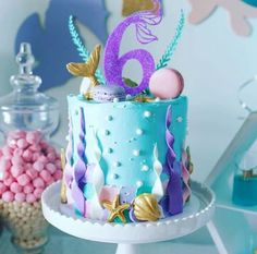 there is a cake with mermaid decorations on it