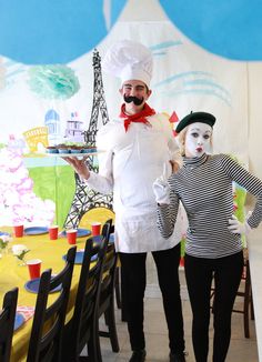 a man and woman dressed up as chefs in front of the eiffel tower