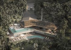 an aerial view of a house in the middle of trees and palm trees surrounding it