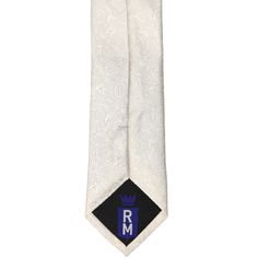 This elegant and timeless ivory slim tie is perfect for your wedding day. The tone-on-tone floral pattern is easy to match and can be worn with just about anything, from fitted groomsmen suits to a simplified tie and suspenders combo. For those in your wedding party who prefer a more traditional tie, this pattern comes in wider widths and bow ties. This is a slim tie, measuring 2.5-inches wide, which is a modern tie size without being too skinny. The pattern has a textured feel and is made from White Fitted Tie For Black Tie Events, Fitted White Ties For Black Tie Occasions, Classic Beige Wedding Suit And Tie Accessories, Classic Beige Suit And Tie Accessories For Wedding, Elegant Cream Standard Tie, Classic White Tie For Groom, Classic White Ties For Groom, Elegant Beige Tie For Black Tie Events, White Fitted Suit And Tie Accessories For Formal Occasions