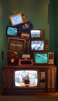 an old tv sitting on top of a wooden stand