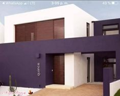 a purple and white building with wooden slats on the front door is seen in this image