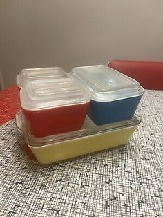 three plastic containers sitting on top of a table