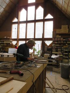 a man is working on woodworking in his workshop