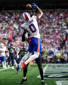 a football player catching a ball in the air