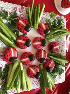 ladybugs and celery are arranged on a plate