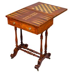 a small wooden table with chess board on it's top and two legs at the base