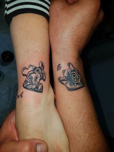 two people with matching tattoos on their arms