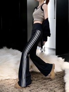 Step into comfort and style with our high-waisted flare leg sweatpants, designed for the fashion-forward individual who loves to mix comfort with modern trends. These sweatpants feature bold side stripes that create a striking visual appeal, perfect for elevating any casual look. Whether you're lounging at home, running errands, or hitting the gym, these sweatpants offer unparalleled comfort with their soft, breathable fabric, while the high-waisted design provides a flattering fit that accentuates your silhouette. Crafted from premium-quality materials, these sweatpants are built to last, offering durability and flexibility for all-day wear. The flare leg adds a retro-inspired twist, making them versatile enough to pair with your favorite crop tops, hoodies, or casual tees for a look that Womens Sweatpants Adidas, Black Full-length Sportswear Bottoms, Flared Joggers, Sporty Wide-leg Sweatpants With Contrast Stripes, Sporty Full-length Bottoms With Side Stripes, Sporty Flare Pants With 4-way Stretch, Flared Sweatpants, Trendy Joggers, Sweatpants For Women