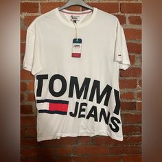 When You Bundle 3+ Items You Receive Discounts And Only Will Pay One Shipping Fee! Most Items Ship Next Day Except Friday-Saturday And Holidays! Please Note Items May Come From Pet Households, All Items Are Clean And Washed But There Still May Be Some Pet Hair Caught In The Fabric! Trendy Tommy Hilfiger Cotton T-shirt, Tommy Hilfiger Cotton T-shirt With Text Print, White Cotton Tommy Hilfiger T-shirt, Tommy Hilfiger Text Print Cotton T-shirt, Tommy Hilfiger Graphic Tee With Letter Print, Tommy Hilfiger White Crew Neck Top, Trendy Tommy Hilfiger Cotton Tops, Trendy Tommy Hilfiger Tops With Graphic Print, Tommy Hilfiger Cotton T-shirt With Letter Print