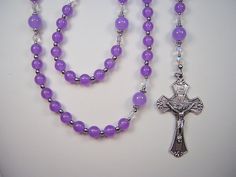 "This Beautiful Rosary is handcrafted with 6mm and 8mm Lavender  Jade Beads. Genuine Gemstones. Czech Glass Crystal  Beads The Rosary is 18\" from top of the Loop to bottom of Cross. (Laid flat) Flared Edge Crucifix  This Beautifully Made Rosary Crucifix features four flared edges.  Made in Italy with a nice silver oxidized finish and is 1 7/8\" long.  Madonna and Jesus Rosary Center Piece This center piece features an image of the Blessed Mother  with a crown of 12 stars on the front, and Jesus Lavender Spiritual Jewelry With Beads, Spiritual Lavender Jewelry With 8mm Beads, Lavender Spiritual Jewelry With 8mm Beads, Adjustable Purple Rosary Bracelet With 8mm Beads, Purple Beaded Rosary Bracelet, Purple And White Crystal Mini Crucifix Rosaries, Purple Rosary With 8mm Round Beads, Purple Rosary With 8mm Beads, Green Rosary With 8mm Beads