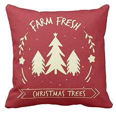 a red pillow with christmas trees and farm fresh written in gold on the front, against a white background