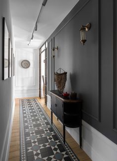 the hallway is painted in dark gray and white