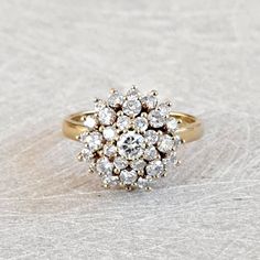 Vintage 1.03 Ctw Diamond Cluster Ring, Floral Design Ring 18K Yellow Gold, Sparkly and Gorgeous! GIA G.G. Appraisal Included 2,490 Usd! A stunning cluster of bright white diamonds, all full round brilliant cut, decorate this crown that measures approximately 13.48mm in diameter and rises 10mm from the finger. The shank is smooth and polished and measures 2mm at the back. Inside the shank is stamped with what is presumed a makers mark of "JF" as well as "18K". This is a wonderful piece for an eng Luxury Gold Cluster Ring With Pave Setting, Vintage Diamond Cluster Rings, Lovely Ring, Diamond Cluster Ring, Fine Jewelry Collection, Diamond Cluster, Vintage Diamond, White Diamonds, Round Brilliant Cut Diamond