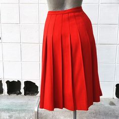 Waist 26 inches Length 26 inches Beautiful, bright red. Excellent condition. Unlined. Wool. Red Retro Pleated Skirt, Red Knee-length Pleated Skirt For Spring, Retro Red Pleated Bottoms, Red Fitted Full Pleated Skirt, Fitted Red Full Pleated Skirt, Red Pleated A-line Skirt, Red A-line Pleated Skirt, Red Lined Pleated Flared Skirt, Red Pleated Flared Skirt With Lining