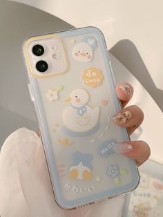 a woman holding up her phone case with some stickers on it