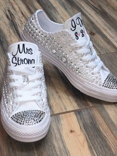 a pair of white shoes with silver sequins on the bottom and one shoe that says, mr & mrs arizona