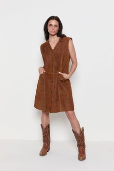 DECADE / 1970 MEASUREMENTS / Shoulder - 16" Bust - 20" Waist - 18" Hips - 23" Length - 37" Sleeve - 5" TAG / MARINA SHORT MATERIAL / Genuine Suede, thick structured suede, fully lined CONDITION / Great TAG SIZE / N/A FIT / Would look great on smaller sizes for an oversized fit. For reference, model is 5'8 and wears a size 2/4. *All Measurements are taken with garment lying flat. -------- VINTAGE ------- All items are vintage and therefore occasionally may have some minimal wear consistent with t Vintage Brown Lined Dress, Retro Brown Dress For Fall, Retro Brown Dress With Buttons, Casual Fitted Vintage Dress For Fall, 1970s Fitted Brown Dress, Fitted Brown 1970s Dress, Fitted Brown 1970s Style Dresses, Sleeveless Vintage Dress For Fall, Brown Vintage Dress For Spring