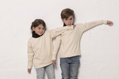 Unisex jumper White organic cotton with turtleneck in black and a a little detail hand embroidered in the left arm. 100% organic cotton. It is a minimal versión of the hand knitted traditional Feroe Jumper. 4 cm hem with invisible stitch that make the item longer as kids grow. Wash. Cold water.Gentle cycle. Do not bleach. No tumble dry. Do not dry clean. Iron inside-out up to 110 C / 230 F. Measurements: - Size 1-2 years: Chest : 78 cm/Lenght. 36 cm - Size 3-4 years: Chest: 82 cm/ Lenght: 39 cm Winter Organic Cotton Long Sleeve Sweater, Organic Cotton Long Sleeve Winter Sweater, Winter Long Sleeve Organic Cotton Top, Organic Cotton Long Sleeve Winter Top, Invisible Stitch, Cream Bags, Kids Jumpers, Kids Sweater, Style Expert