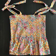 J Crew Multi Color Floral Print Smocked Tank Top. Adjustable Tie Shoulder Straps. Great Condition, Never Worn Multicolor Sleeveless Smocked Back Top, Multicolor Sleeveless Smocked Top With Floral Print, Summer Cotton Smocked Top With Floral Print, Spring Multicolor Tops With Drawstring, Sleeveless Smocked Top With Floral Print For Summer, Sleeveless Smocked Top With Smocked Cuffs, Cotton Smocked Top With Floral Print For Day Out, Summer Multicolor Smocked Top With Smocked Cuffs, Multicolor Summer Top With Smocked Cuffs