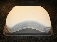 a white cake sitting on top of a metal pan