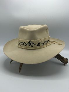 Teton Creme – JW Bennett Handmade Adjustable Formal Hats, Adjustable Beige Hat Bands For Formal Occasions, Traditional Adjustable Hat For Formal Occasions, Handmade Artisan Beige Hat Bands, Handmade Western Beige Hat Bands, Elegant Handmade Hat Bands For Rodeo, Artisan Beaded Hat Bands For Western-themed Events, Mountain Style, Leather Tie