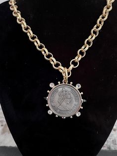 I made this necklace using a reproduction coin that features Queen Elizabeth II. I used a gold colored alloy metal chain that is nickel free. I closed it with a toggle closure. Offered in a variety of lengths. Vintage Gold-tone Chain Necklace With Coin Pendant, Vintage Metal Medallion Necklace With Coin Pendant, Vintage Coin Shaped Medallion Necklace, Metal Medallion Necklace With Gold Chain, Gold-tone Medallion Chain Necklace, Medallion Necklace With Gold Chain, Vintage Gold Metal Toggle Necklace, Gold Coin Necklace Nickel Free, Vintage Gold-tone Coin Necklace