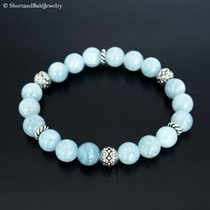 "❖ AQUAMARINE: Natural 8mm gemstone ❖ ♥ Cleansing ♥ Meditation ♥ Serenity ♥ Peace ♥ Prophecy ♥ Inspiration ♥ Tranquility ♥ Inner power strength ♥ Soothing ♥ Calming ♥ Safe travel on water ❖ SPACERS & SILVER BEADS : Antique pewter charms made in USA. ❖ Durable Elastic Stretch Cord. ❖ The gemstones are natural, so you may see some variations. ❖ Your purchase will arrive attractively packaged and ready to give. ❖ Size ❖ Women Small: Fits 5.5\" - 6\" Women Medium: Fits 6\" - 6.5\" Women Large: F Elegant Light Blue Jewelry With 8mm Beads, Aquamarine Gemstone Beaded Bracelets For Healing, Light Blue Aquamarine Beaded Bracelets As Gift, Elegant Blue Amazonite Beaded Bracelets, Elegant Aquamarine Beaded Bracelets, Spiritual Light Blue Bracelets With Round Beads, Blue Amazonite Beaded Jewelry, Elegant Blue Amazonite Bracelets, Spiritual Light Blue Jewelry With 8mm Beads