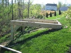 a wooden bench sitting on top of a lush green field