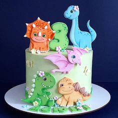 there is a cake decorated with dinosaurs on it