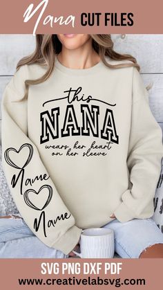 a woman wearing a sweater that says the nana and is holding a coffee mug