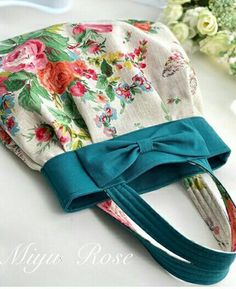 a flowered pouch with a bow on it