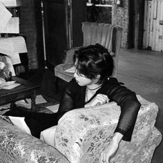 a woman sitting on top of a couch in a living room