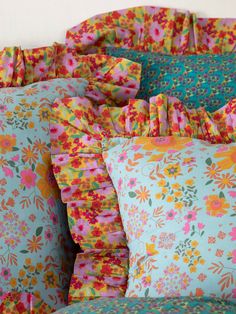 colorful pillows with ruffles and flowers on them