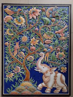 an intricately painted elephant and tree on a blue background with gold trimmings