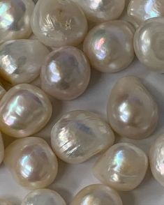 many different types of pearls on a white surface