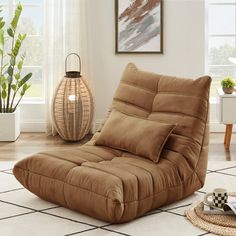 a brown reclining chair sitting on top of a rug in front of a window