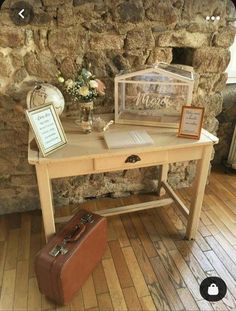 a wooden desk with a suitcase on top of it and a sign next to it